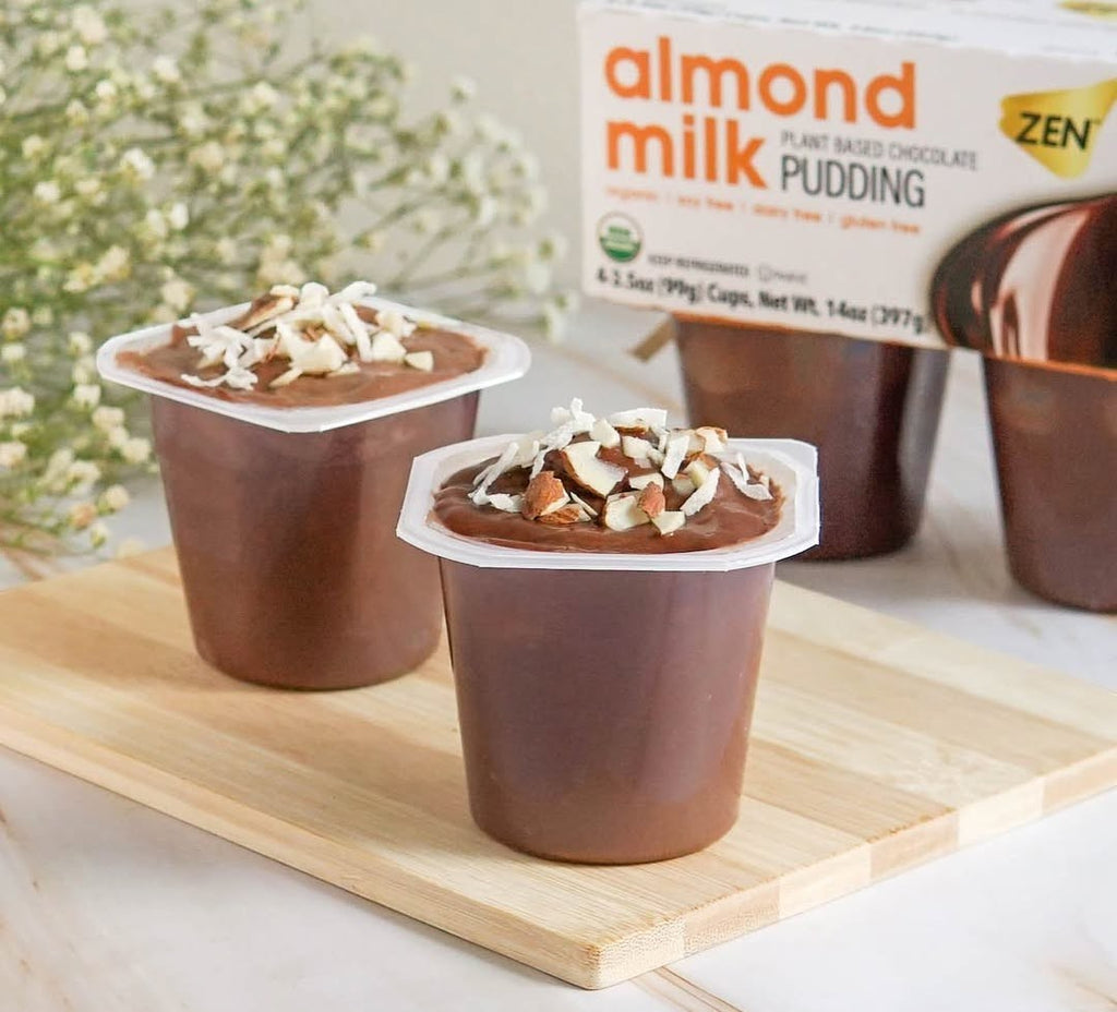 Zen almond milk chocolate pudding cups topped with chopped almonds and shredded coconut. Dairy-free, gluten-free treat.